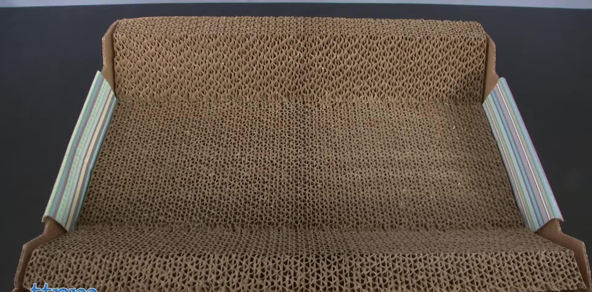 Close-up of the SmartyKat Super Scratcher Chaise, showcasing its corrugated cardboard design and cat-cradling shape.