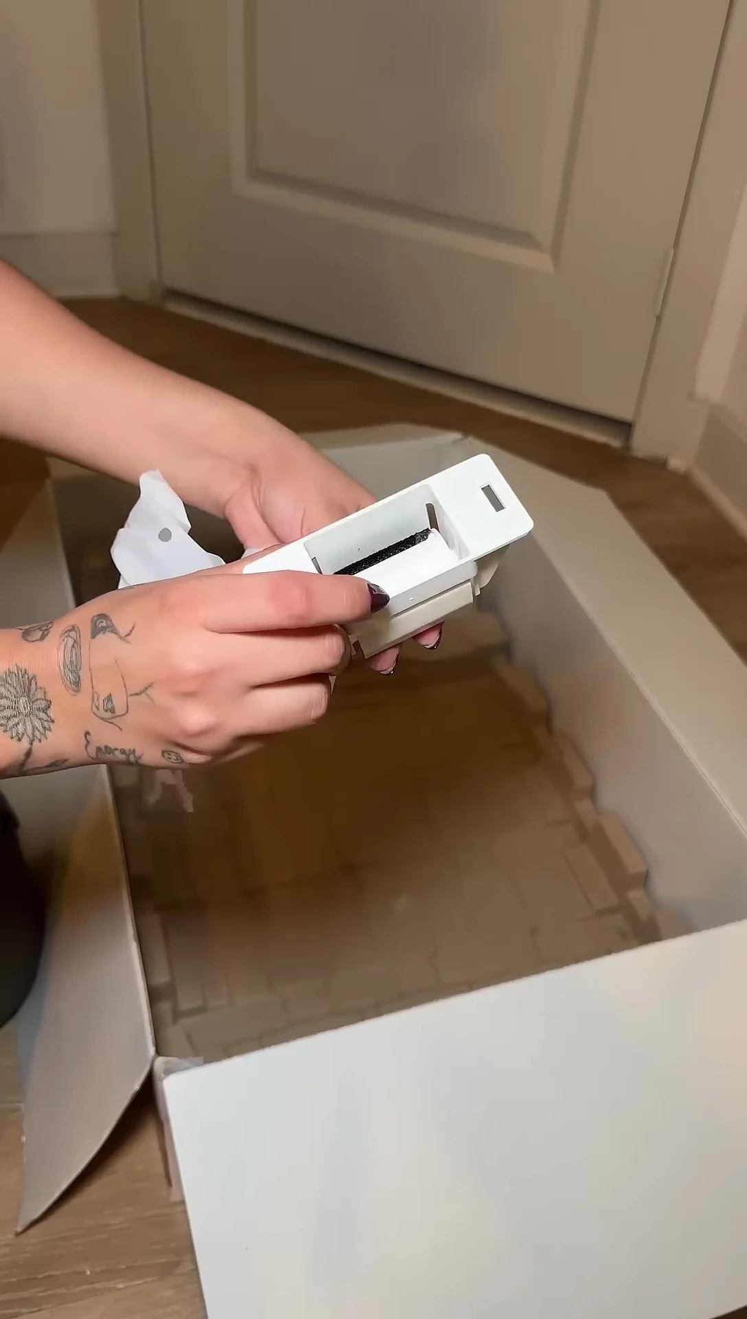 The PawSwing Auto Comb Pro's components laid out before assembly.