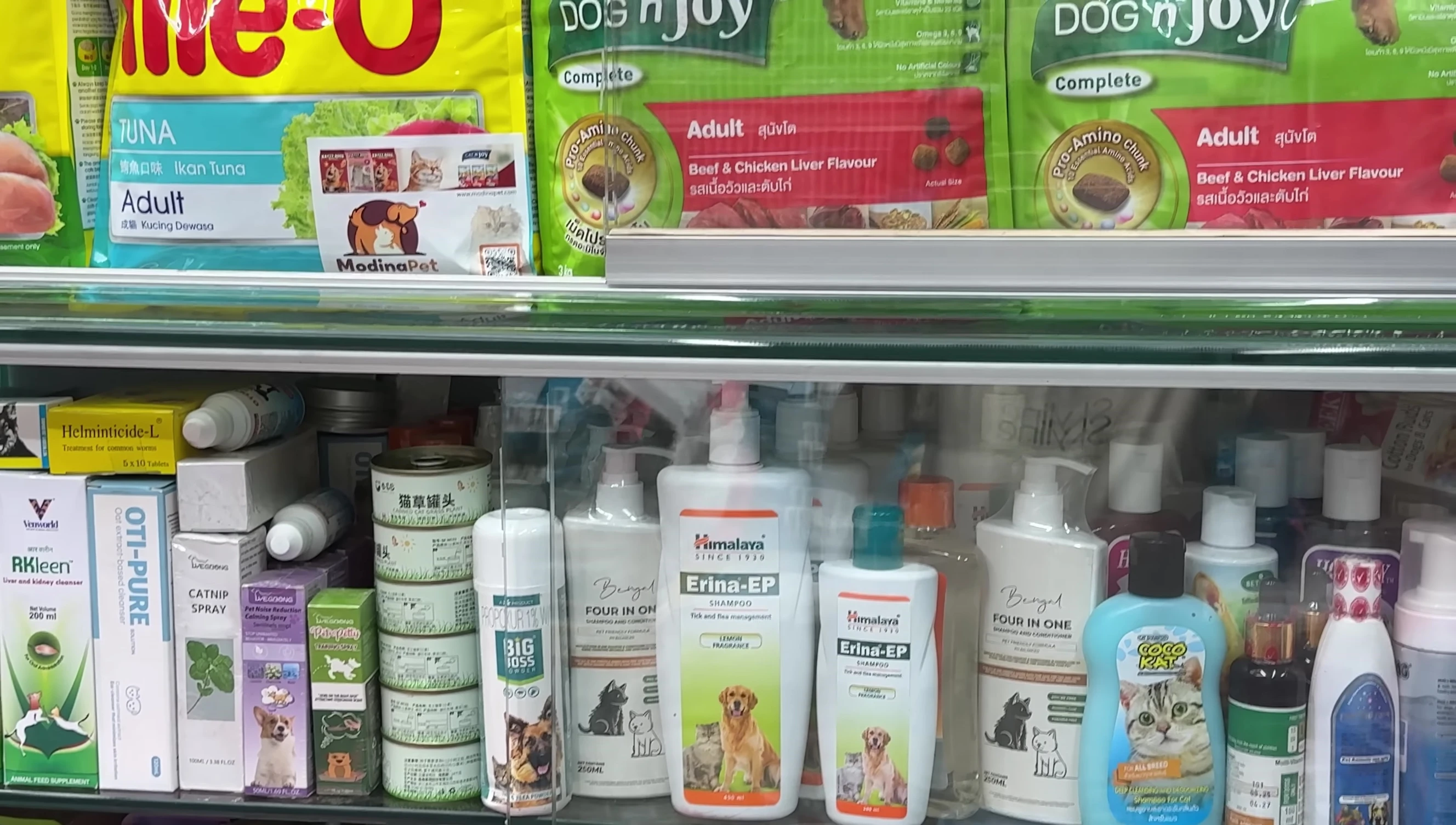 Assortment of wet and dry pet food brands.