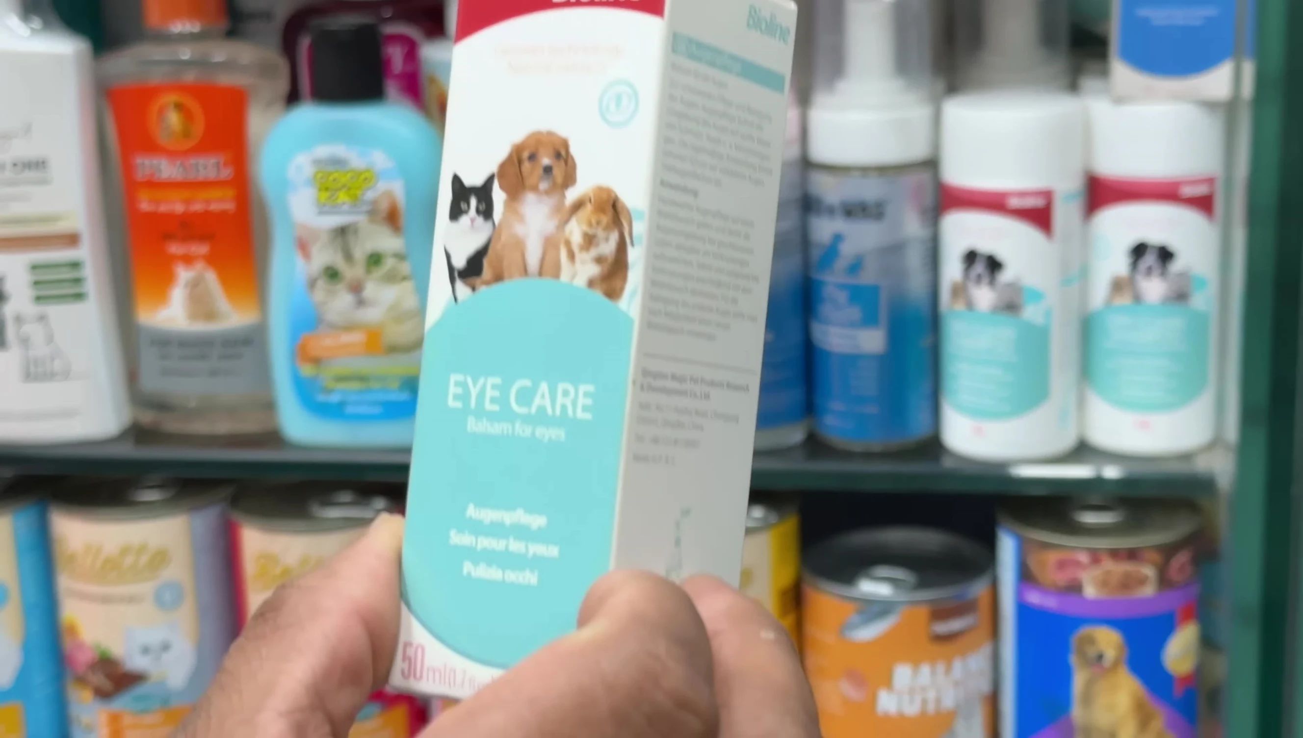 Various shampoos and eye care products displayed on shelves.