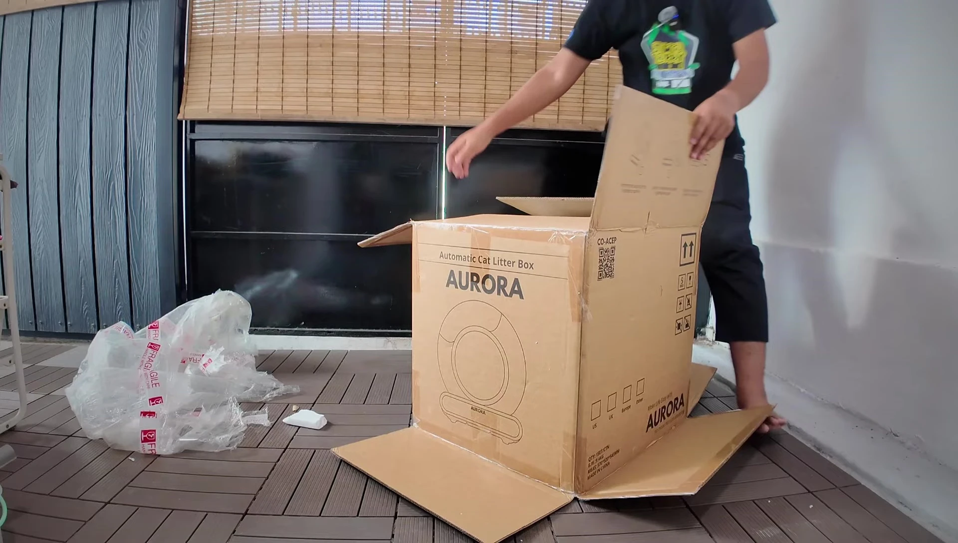 The large litter box being carefully removed from the packaging.