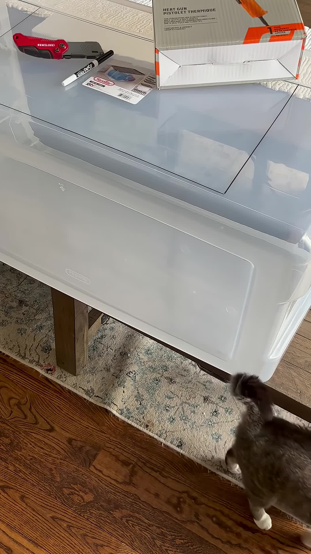 Marking the plastic tote to indicate where to cut.