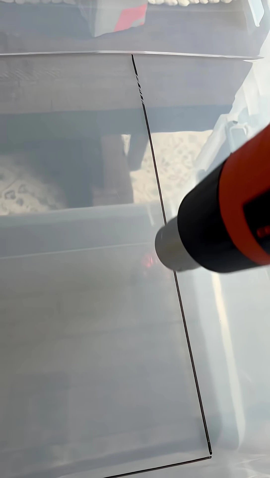 Using the heat gun and X-acto knife to cut a section.