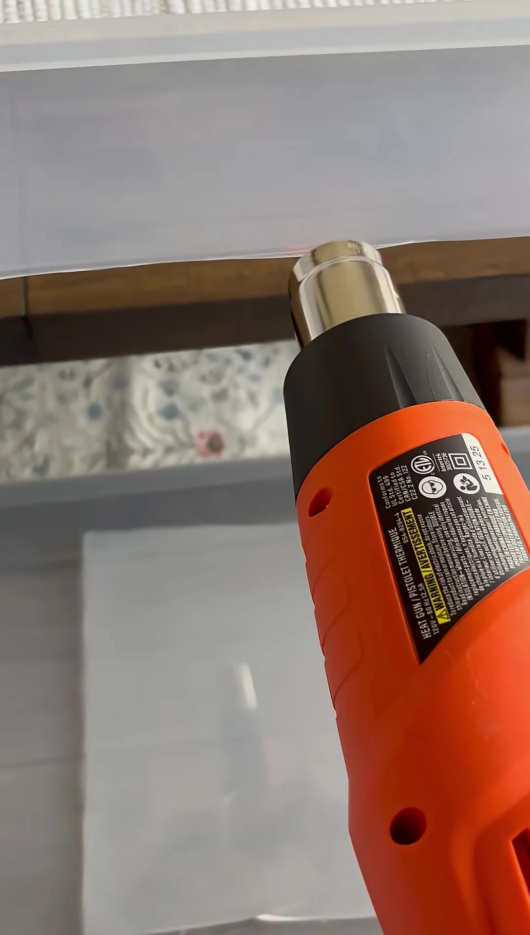 Smoothing the edges of the cut plastic with the heat gun.